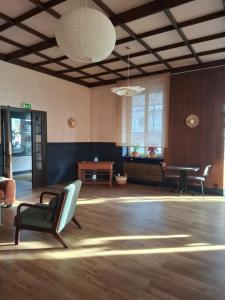 a large room with chairs and a table in it at Le Grand Hôtel Ussel ''nouvelle Gérance 2023'' in Ussel