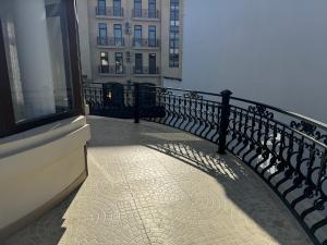 a balcony with a black fence and a building at B&B Apartment Farhad Hospitality Solutions in Samarkand