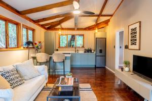 a living room with a couch and a table at The Cabin Luxury Safari Villa, Private Pool, Hot tub, Outdoor Shower, Giraffe Tower, Free Standing Bath, Private Game Reserve, Romantic Getaway, Ultimate Bush Luxury in Hluhluwe