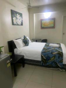 a bedroom with a bed and a table at Matasawa Resort - Wailoaloa, Nadi in Nadi