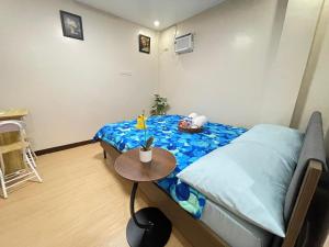 a small room with a bed and a table at Potot Haven Dorm and Transient in Libmanan