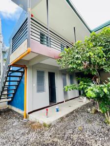 a house with a staircase in front of it at Potot Haven Dorm and Transient in Libmanan