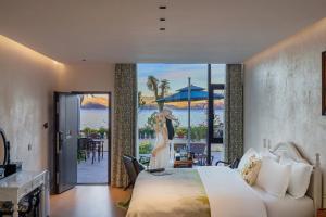 a bedroom with a bed and a view of the ocean at Blue Sea Hotel in Dali