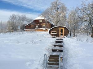 a house in the snow with a set of stairs at Kossa Tarõ in Luhamaa