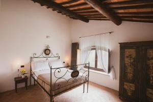 a bedroom with a bed and a window in it at Historic Villa Among Olive Groves In Arezzo in San Polo