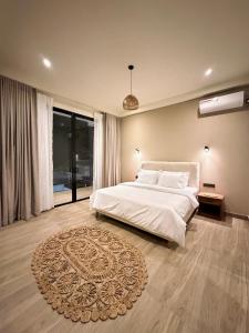 a bedroom with a white bed and a rug at La Vizta Weligama in Weligama +65 photos