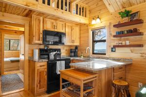 a kitchen with wooden cabinets and a black stove top oven at P-Bay The Roost home in Reeds Spring