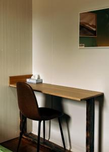 einen Schreibtisch mit einem Stuhl neben einer Wand in der Unterkunft Bluff House Flinders Island Tasmania in Whitemark