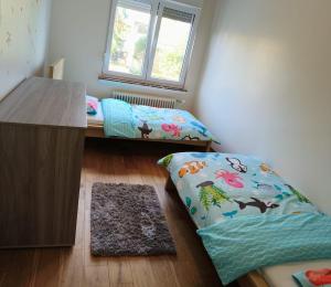 a room with a bed and a desk and a window at Cozy&Spacious apartment with garden in Antwerp +2 photos