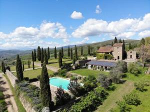 an estate with a swimming pool and a house at Rustico Restaurato Sulle Colline Di Arezzo in San Polo
