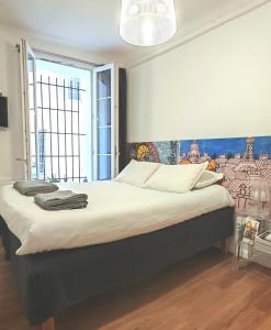 a bedroom with a large bed with a painting on the wall at Studio centre historique derrière rue d'Italie - Climatisé in Aix-en-Provence