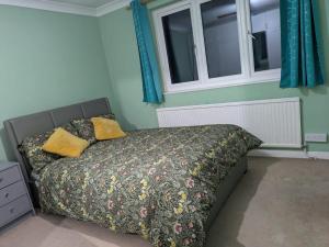 a bedroom with a bed and two windows at Large Central Lodge Near Heathrow Airport & London with Parking in Langley Station