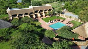 an overhead view of a house with a swimming pool at Vakasha Lodge in Siphofaneni