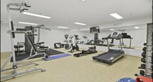 a gym with several treadmills and cardio machines at Bugalmaa - Cotton Beach in Casuarina