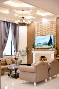 a living room with a couch and a fireplace at An Nhiên Hotel & Villa Da Lat in Da Lat