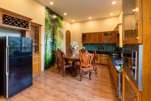 a kitchen with a dining room table and chairs at An Nhiên Hotel & Villa Da Lat in Da Lat