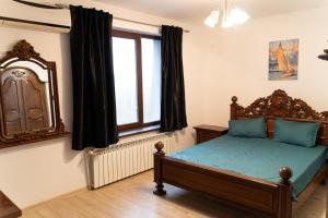 a bedroom with a bed and a window at CASA Don Lucio in Craiova