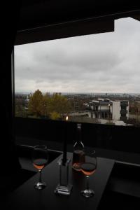 a table with two glasses and a bottle of wine at CASA Don Lucio in Craiova
