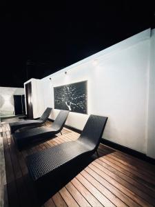 a group of chairs lined up against a white wall at La Vizta Weligama in Weligama