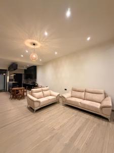 a living room with two couches and a table at La Vizta Weligama in Weligama