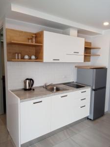 a kitchen with white cabinets and a sink at Stylish Urban Escape 1Bed Apt T2-822 in Ban Klang