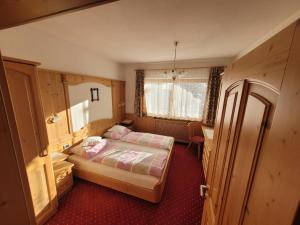 een kleine slaapkamer met een bed en een bureau bij Chalet Milandora in La Villa