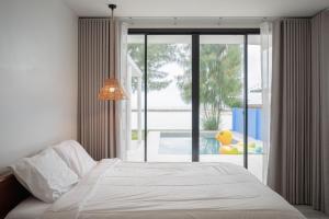 Voodi või voodid majutusasutuse The Seacation Pool Villa toas +14 fotot