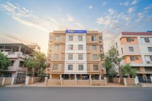 a building with a blue sign on top of it at FabHotel 24 Baner - Nr MCF Camp in Pune