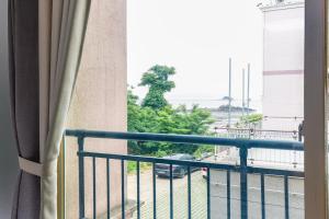 a room with a balcony with a view of a street at 온담펜션 