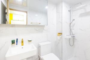 a white bathroom with a sink and a shower at 온담펜션  +5 photos