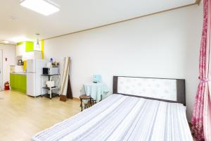 a bedroom with a bed and a table in it at 온담펜션 