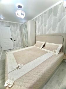 a large bed in a room with at Appartament Shymkent in Shymkent