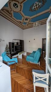 a living room with blue furniture and a christmas tree at Center Haus in Bucharest