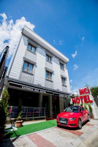 a red car parked in front of a building at Express İnci Hotel in Istanbul