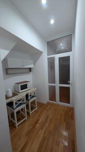 a small kitchen with a table and a microwave at Center Haus in Bucharest +12 photos