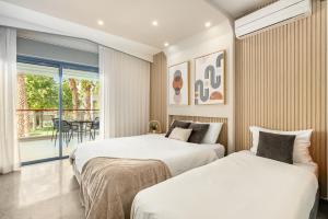 2 bedden in een kamer met een balkon bij Royal Park Residence by Sea N' Rent in Eilat