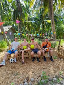 a group of men sitting on chairs with balls at Neena S House in Koh Phangan