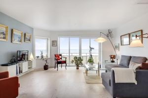 a living room with a couch and a table at Strandhuset B&B in Tranekær