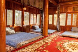 a bedroom with two beds in a room with windows at Sapa Garden Retreat in Sa Pa