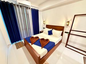 a bedroom with two beds with hearts on them at Devon Surf . Inn - Hiriketiya in Dickwella