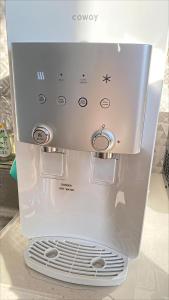 a microwave oven sitting on top of a refrigerator at Leisure29 Suites in Kuantan