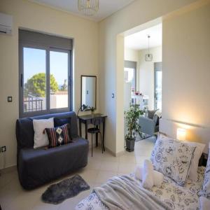 a living room with a couch and a table at Alba - Open Plan Apartment in Artemida