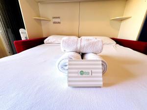 a hotel room with towels on a bed at Suite Semeria 129 - Sanremo in Sanremo +6 photos