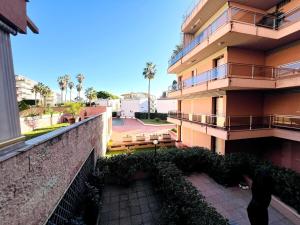 an apartment building with a balcony and a courtyard at Suite Semeria 129 - Sanremo in Sanremo