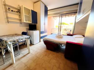 a small room with a bed and a table at Suite Semeria 129 - Sanremo in Sanremo