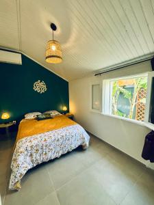 a bedroom with a bed and a window at La case d'Édith in Le Tampon +42 photos