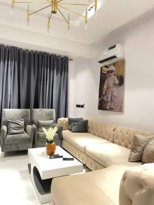 a living room with a couch and a table at The Roomist in Lekki