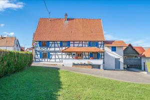 a white and blue house with red roofs at La Maison Schmoutz in Forstheim