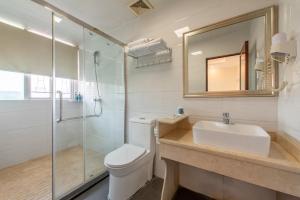une salle de bain avec toilettes, lavabo et douche dans l'établissement Sanjun Hotel, à Canton