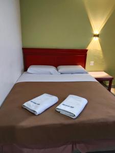 Ένα ή περισσότερα κρεβάτια σε δωμάτιο στο Megah Inn Home Inanam